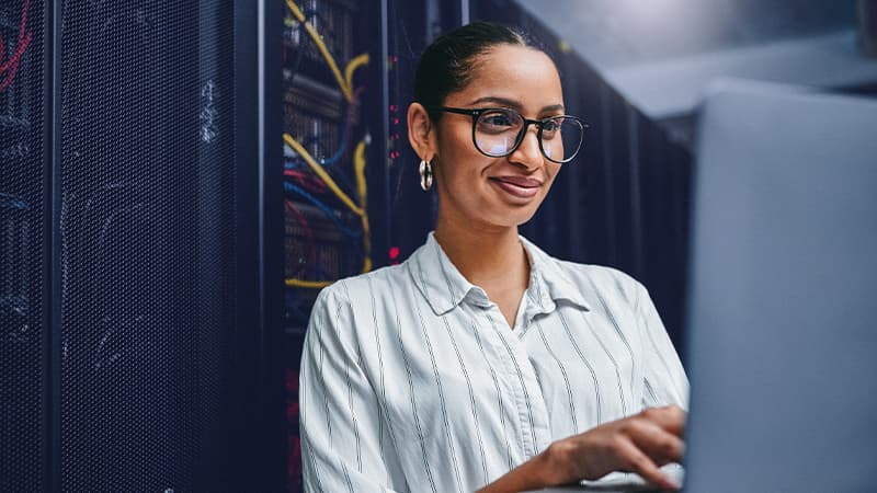 GLO Case Study - Discover how we helped a technology firm secure the right candidate by going beyond regional limits - Smiling Lady Working In Data Centre