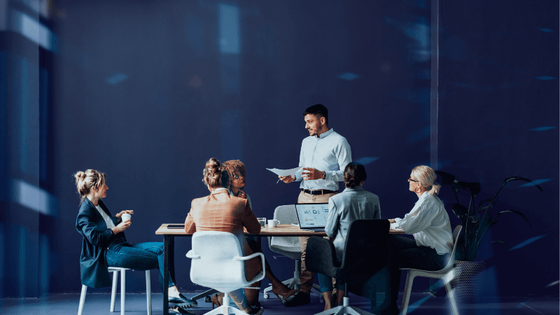 Senior Technology Leaders In A Meeting Reviewing A Digital Project, Representing The Need For Deployment Talent To Turn AI Investment Into Business Value.